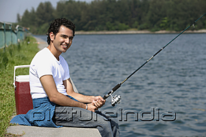 PictureIndia - Young man fishing in river
