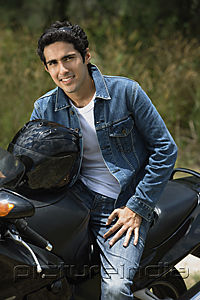 PictureIndia - Young man riding motorbike