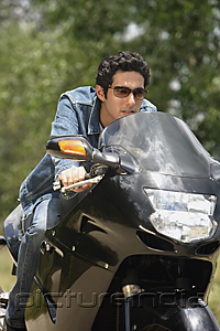 PictureIndia - Young man riding motorbike