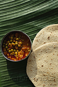 PictureIndia - Still life of chapati and mixed vegetable curry on a banana leaf