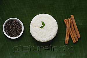 PictureIndia - Still life of cinnamon sticks, black pepper and basmati rice