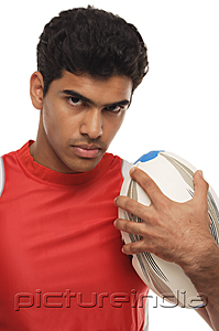 PictureIndia - Young man with rugby looking at camera