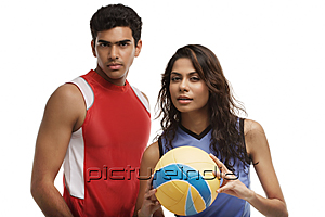 PictureIndia - Young couple with beach ball looking at camera