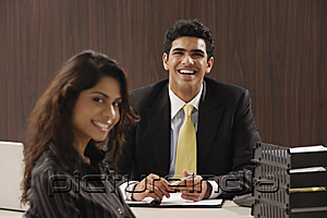 PictureIndia - Businessman and woman smiling at camera
